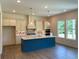Beautiful kitchen includes an island with a breakfast bar, white cabinets, and a stylish tile backsplash at 679 Crest Line Trl, Powder Springs, GA 30127