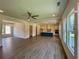 Open-concept kitchen and living area boasts wood flooring, a modern island, and plenty of natural light at 679 Crest Line Trl, Powder Springs, GA 30127