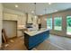 Bright kitchen with a functional island, modern cabinetry, and views of the backyard at 679 Crest Line Trl, Powder Springs, GA 30127