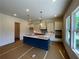 Bright, spacious kitchen boasts a blue island, stylish backsplash, and ample cabinet space at 679 Crest Line Trl, Powder Springs, GA 30127