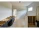 Kitchen featuring dark cabinets, a view to the next room, and unfinished flooring at 679 Crest Line Trl, Powder Springs, GA 30127