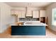 Kitchen showcases a center island with navy blue base, white cabinets, and tiled backsplash at 679 Crest Line Trl, Powder Springs, GA 30127