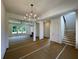 Open concept living room with a chandelier, staircase, and neutral paint at 679 Crest Line Trl, Powder Springs, GA 30127