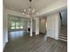 Spacious living room showcasing wood floors, fireplace, staircase, and open concept design at 679 Crest Line Trl, Powder Springs, GA 30127