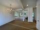 Living room featuring a chandelier, neutral paint, and open floorplan at 679 Crest Line Trl, Powder Springs, GA 30127