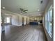 Open-concept living space connecting kitchen with light-filled windows and a modern ceiling fan at 679 Crest Line Trl, Powder Springs, GA 30127
