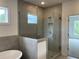 Close up on a shower with light gray tiling and glass enclosure at 679 Crest Line Trl, Powder Springs, GA 30127