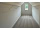 A long walk-in closet, carpeted, with wire shelving and natural light at 679 Crest Line Trl, Powder Springs, GA 30127