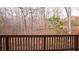 Back deck overlooking wooded backyard, providing a serene and private outdoor space at 1320 Newbridge Cir, Buford, GA 30519