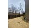 Large backyard featuring a sturdy, dark wood fence, and the house is on the right at 1320 Newbridge Cir, Buford, GA 30519