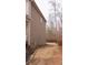 Side yard of home with a wood fence and view of wooded area in the distance at 1320 Newbridge Cir, Buford, GA 30519