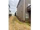 View of side yard showing grass, and exterior of home at 1320 Newbridge Cir, Buford, GA 30519