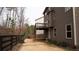 Large fenced backyard with deck and brown siding at 1320 Newbridge Cir, Buford, GA 30519