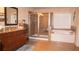 A bathroom featuring a tiled shower, soaking tub, and double vanity with granite counters at 1320 Newbridge Cir, Buford, GA 30519