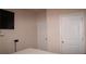 Minimalist bedroom with two doors and a mounted television at 1320 Newbridge Cir, Buford, GA 30519