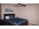 Comfortable bedroom with dark leather bedframe and blue patterned bedding at 1320 Newbridge Cir, Buford, GA 30519