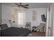 Bright bedroom showcasing a bed with a gray quilt, decor and stylish side chairs and tables at 1320 Newbridge Cir, Buford, GA 30519