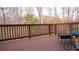 Back deck featuring stained wood, black outdoor furniture, a wooded view and metal bike decor at 1320 Newbridge Cir, Buford, GA 30519