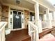 Charming covered front porch with stone accents and decorative 'Sweet Home' door wreath at 1320 Newbridge Cir, Buford, GA 30519