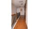 Upstairs hallway featuring hardwood floors, wood banister, and a barn door at 1320 Newbridge Cir, Buford, GA 30519