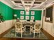 Bright office with green walls, white trim, coffered ceiling, designer rug, and a decorative light fixture at 1320 Newbridge Cir, Buford, GA 30519