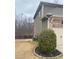 Side view of the house showing siding and brick accents with a well-maintained yard at 1320 Newbridge Cir, Buford, GA 30519