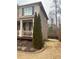 Property side yard featuring trimmed evergreen and tidy lawn at 1320 Newbridge Cir, Buford, GA 30519