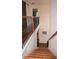 Wooden staircase featuring wrought iron railing leading up to the second floor and a barn door detail at 1320 Newbridge Cir, Buford, GA 30519