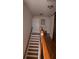 Stairway with wooden railing, white risers, and view of the upstairs hallway at 1320 Newbridge Cir, Buford, GA 30519