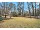 Spacious backyard with wooden fence and playset at 1519 Carnaby Ct, Dunwoody, GA 30338