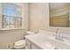 Bright bathroom with a large window, white vanity and tiled shower/tub at 1519 Carnaby Ct, Dunwoody, GA 30338