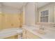 Traditional bathroom featuring yellow tile, a tub, and a vanity with ample counter space at 1519 Carnaby Ct, Dunwoody, GA 30338