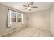 Light filled bedroom showcasing carpeted floors, ceiling fan, and large window at 1519 Carnaby Ct, Dunwoody, GA 30338