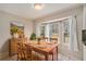 Charming dining area with a bay window and rustic wooden table at 1519 Carnaby Ct, Dunwoody, GA 30338