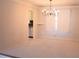 Bright dining room featuring a chandelier, window with sheer curtains, and access to the kitchen at 1519 Carnaby Ct, Dunwoody, GA 30338