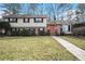 Attractive two-story house with brick and siding exterior, landscaping, and walkway at 1519 Carnaby Ct, Dunwoody, GA 30338