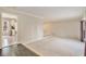 Open living area with a view into the kitchen, featuring tile and carpeted areas at 1519 Carnaby Ct, Dunwoody, GA 30338