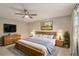 Spacious main bedroom with a ceiling fan, natural light, and a calming color palette at 1519 Carnaby Ct, Dunwoody, GA 30338