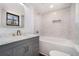 Updated bathroom with grey tile and a grey vanity at 942 Azalea Cir, Marietta, GA 30062