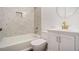 Modern bathroom with white vanity, grey tile, and gold fixtures at 942 Azalea Cir, Marietta, GA 30062