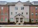 Brick front exterior of a charming townhome with a two-car garage at 1208 Stone Castle Cir # 3, Smyrna, GA 30080