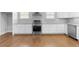 Modern kitchen with stainless steel appliances and hardwood floors at 1208 Stone Castle Cir # 3, Smyrna, GA 30080