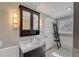 Well lit bathroom with a stylish vanity, neutral walls, modern lighting, and decorative storage at 202 Heights Pl, Canton, GA 30114
