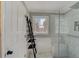 Bright bathroom features a glass shower, tile surround, and a decorative ladder for storage at 202 Heights Pl, Canton, GA 30114