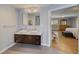Modern bathroom featuring double sinks, wood-look flooring, and bedroom view at 202 Heights Pl, Canton, GA 30114