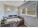 Relaxing bathroom with a luxurious soaking tub, modern fixtures, and natural light at 202 Heights Pl, Canton, GA 30114