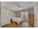 Cozy bedroom with hardwood floors, a ceiling fan, and a large window at 202 Heights Pl, Canton, GA 30114