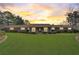 Beautiful home with lush green lawn and mature trees at sunset at 202 Heights Pl, Canton, GA 30114