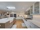 Bright kitchen with stainless steel appliances, white cabinetry, island with prep sink and hardwood floors at 202 Heights Pl, Canton, GA 30114