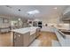 Bright kitchen featuring an island with prep sink, stainless steel appliances, and modern white cabinets at 202 Heights Pl, Canton, GA 30114
